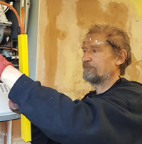 heating engineer servicing a boiler